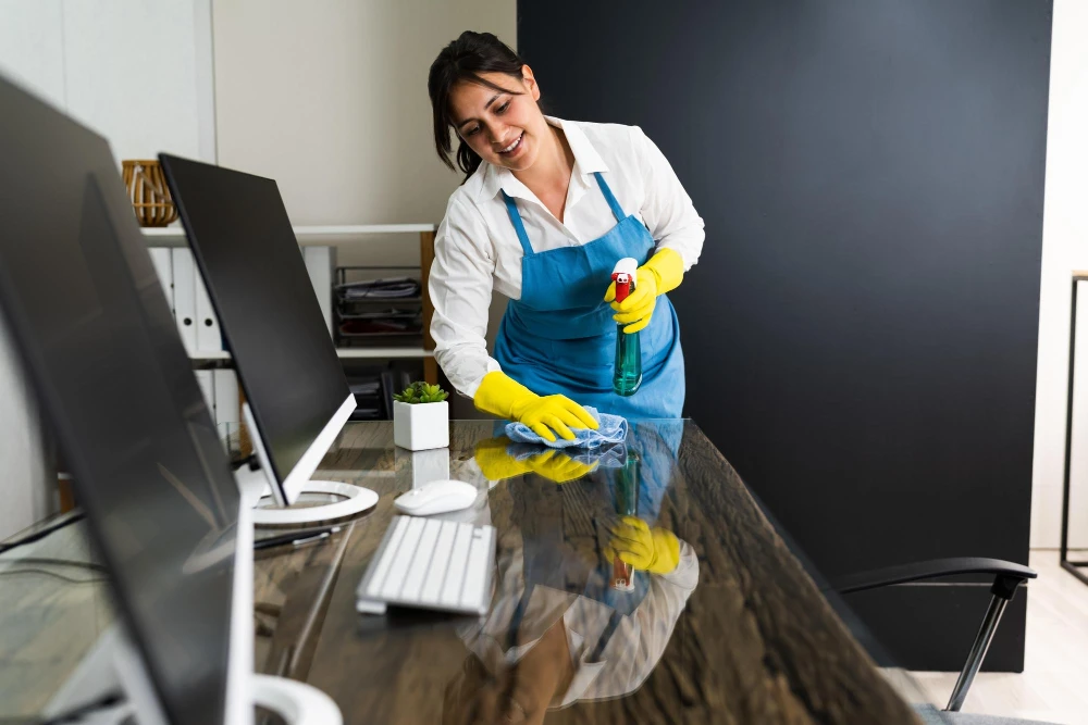 Commercial office cleaning team disinfecting workstations in Miami
