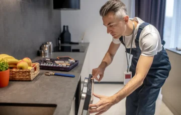 man-looking-information-control-panel-dishwasher man-looking-information-control-panel-dishwasher