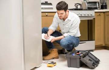 portrait-handsome-male-technician-doing-work-report-broken-fridge-home-kitchen portrait-handsome-male-technician-doing-work-report-broken-fridge-home-kitchen
