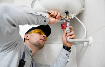 worker-repairing-water-heater worker-repairing-water-heater